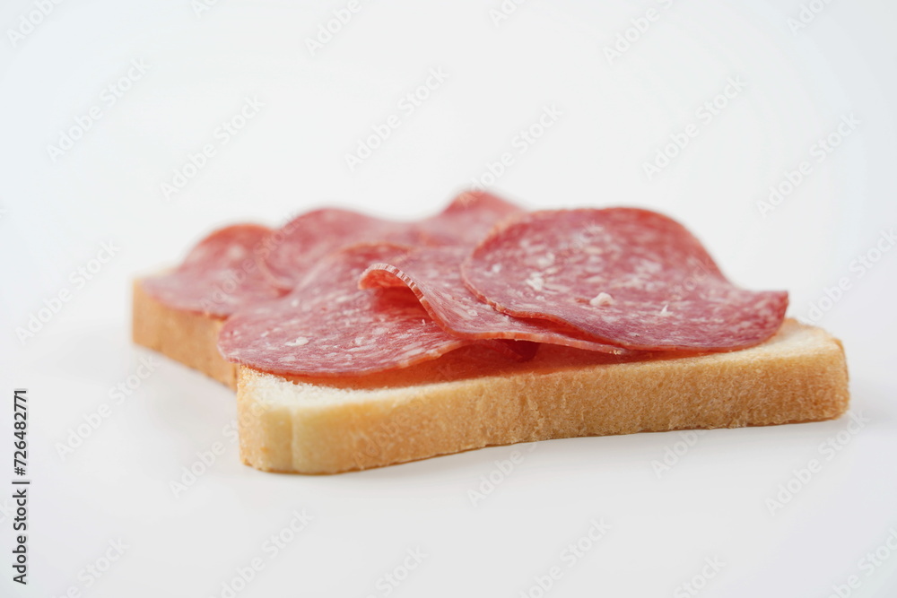 Salami sandwich. Open sandwich of salami slices, thin cut. Spanish salami with spices on  bread.