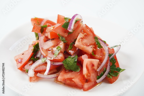 Salad with fresh tomatoes, olive oil, onions, parsley and fennel.