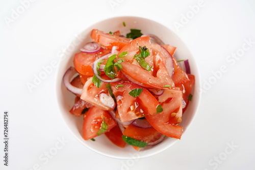 Salad with fresh tomatoes, olive oil, onions, parsley and fennel.