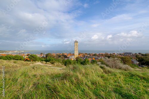 Small town in West-Terschelling under blue sky, Brandaris lighthouse (Vuurtoren Brandaris) on the Dutch Wadden Sea island Terschelling, A municipality and an island in northern Friesland, Netherlands.