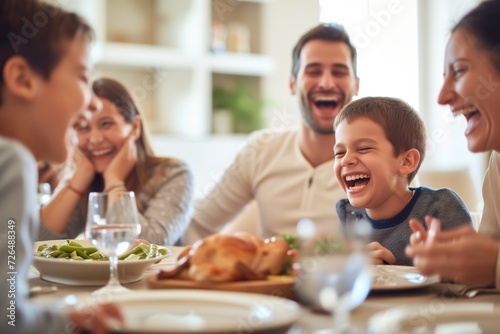 family at a dinner table laughing at a childs joke