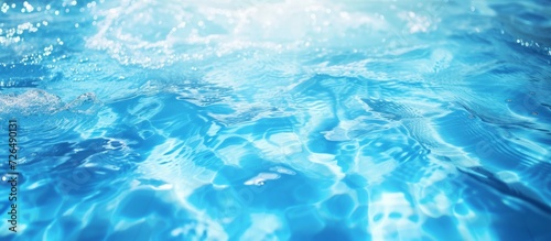 Blurry blue watercolor in swimming pool with rippled detail; background of water splash and spray.