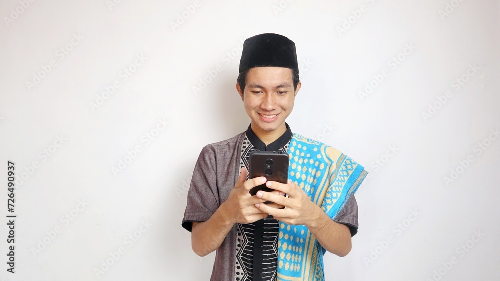asian muslim man smiling with gesture holding playing typing smartphone asian muslim man smiling with gesture holding playing typing smartphone