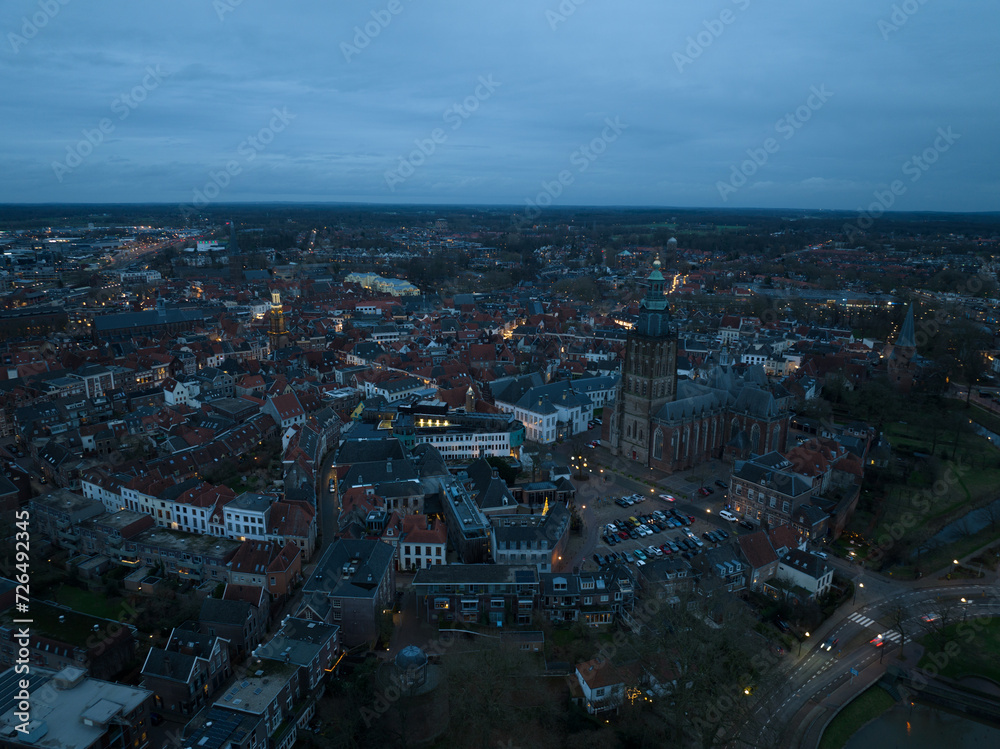 Aerial overview at dusk of the city of Zutphen, along the river Ijssel in Gelderland, The Netherlands. Birds eye aerial drone view in the Dutch province of Gelderland.