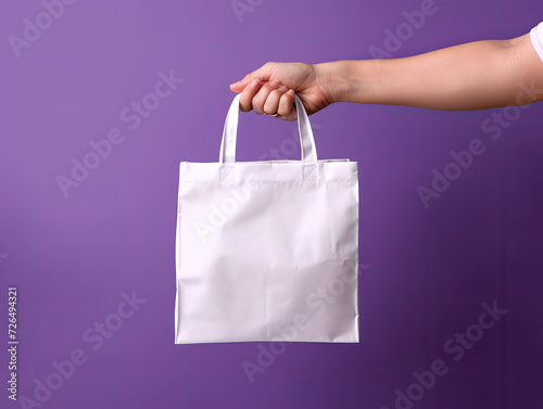 Hand Holding Blank White Tote Bag Against Purple Background - Generative AI