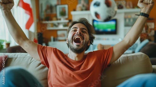 Group of friends cheering on a football match in the living room are celebrating their team's goal. photo