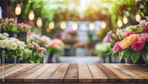 wooden table, empty and inviting, set against a vibrant, blurred flower shop backdrop - a versatile stock photo for diverse creative concepts © Your Hand Please