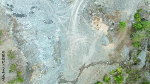 A drone's eye view descends over the textured quarry site in Puerto Princesa, Palawan, highlighting the earthy tapestry of stone and sand. photo