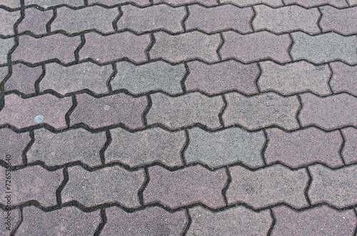 Texture of cobblestone. Pattern of sidewalk tiles in the street. 