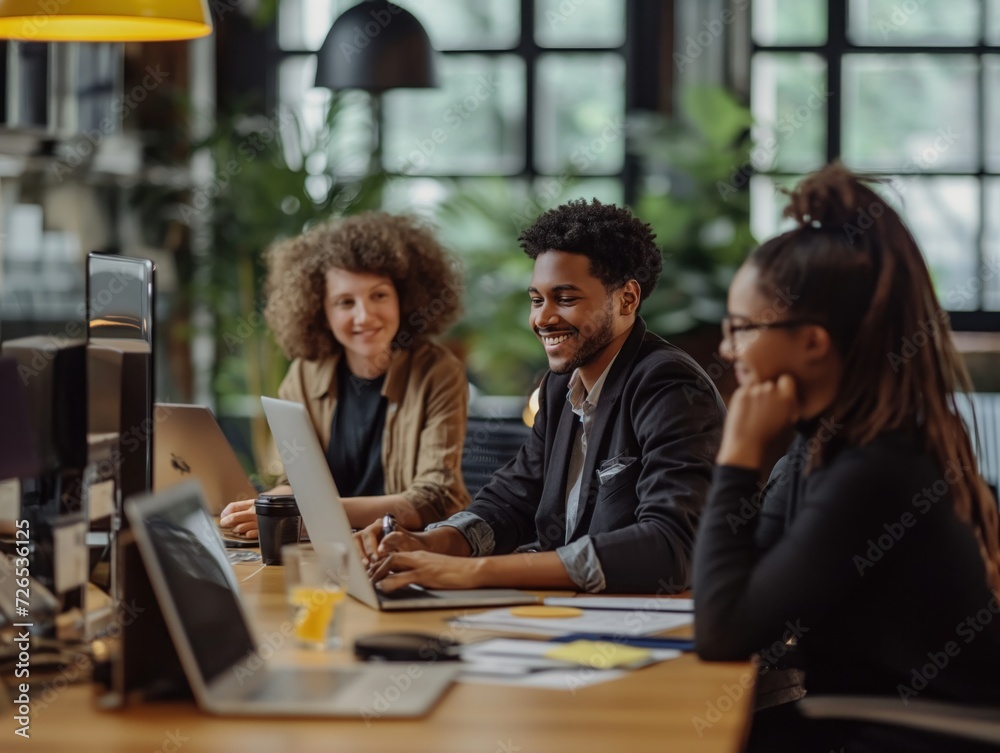 A diverse team collaborating on a project in a hybrid office environment A diverse team collaborating on a project in a hybrid office environment