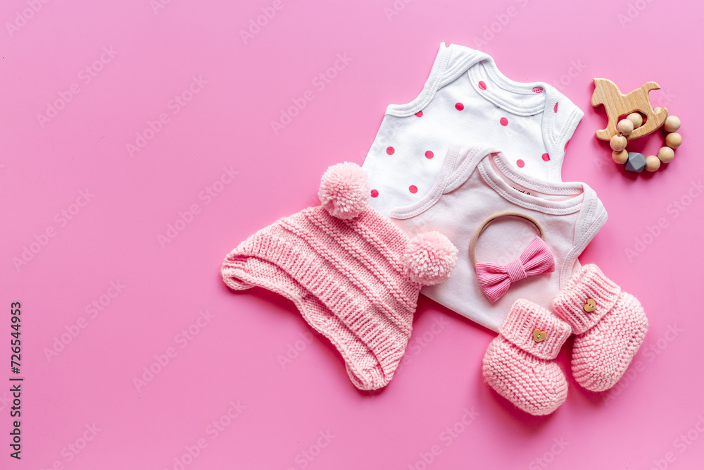 Flat lay of pink baby clothing and accessories. Kids bodysuit and shoes flat lay