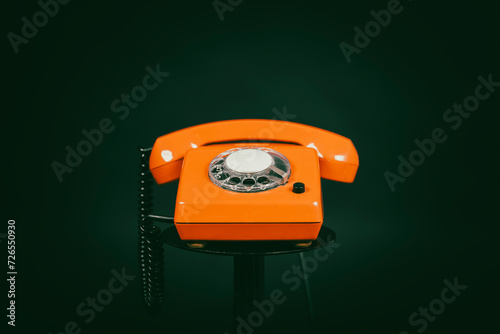 An old red telephone with a rotary dial, an old historical red telephone, still life of an old red telephone photo