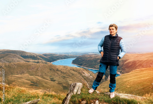 Wallpaper Mural Woman reaching the destination and on the top of mountain against cloudy blue sky on autumn day Travel Lifestyle concept The national park Lake District in England Torontodigital.ca