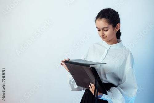 Studio shot of girl opening her briefcase and ready for school