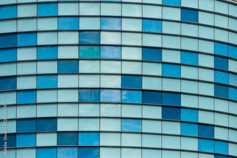 Pattern of windows of office buildings illuminated in the morning. Glass architecture; corporate building - business concept. Pattern of windows of office buildings illuminated in the morning. Glass architecture; corporate building - business concept.