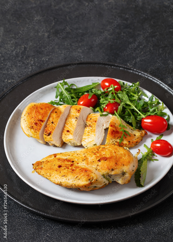 fried chicken breasts with green salad on plate fried chicken breasts with green salad on plate