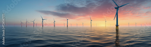 offshore wind turbines in moderate swell at sunrise. wind turbines in the fog