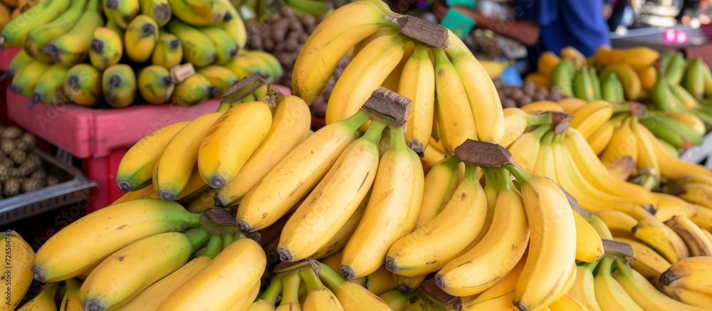 Large quantity of ripe yellow bananas and various tropical fruits available at the turkey farmers market.