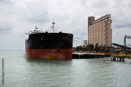 large ship docked in Gladstone on a cloudy day photo