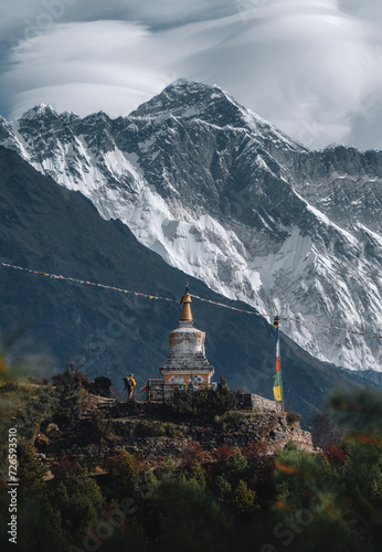A mountaineer with a backpack observes the great mountain of Pumori while making the ascent to Everest Base Camp in the Himalayas Nepal