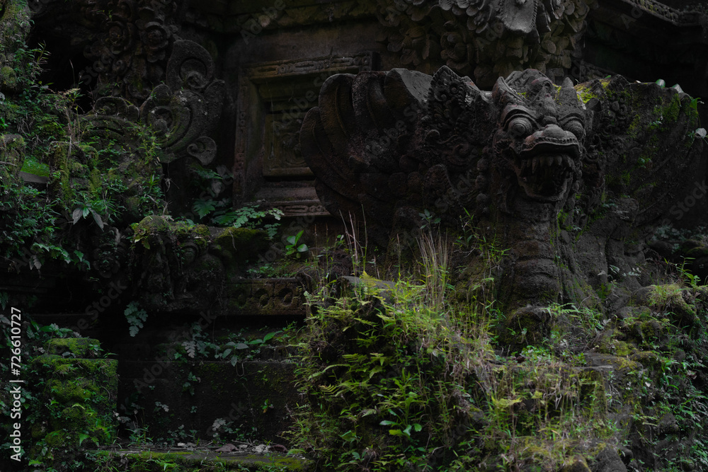 details of indonesian ancient temple, dark stone tropical wall.