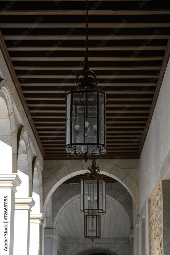 Ancient lamps in building porch, Segovia, Spain