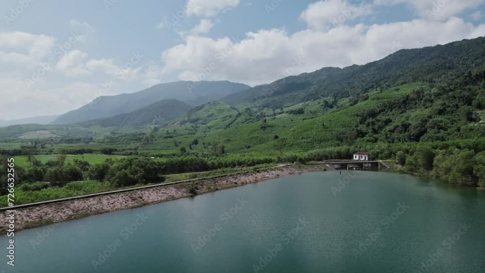 Scenic landscape featuring a tranquil reservoir with a small dam surrounded by lush greenery and mountains conveying a sense of serenity and natural beauty Scenic landscape featuring a tranquil reservoir with a small dam surrounded by lush greenery and mountains conveying a sense of serenity and natural beauty