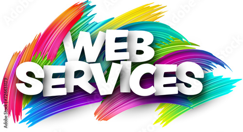 Web services paper word sign with colorful spectrum paint brush strokes over white.