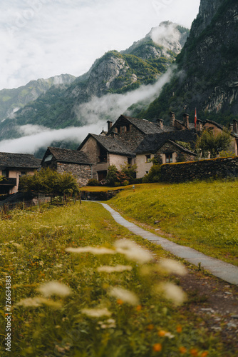 Sonogno village in Swiss alps with waterfall nearby.