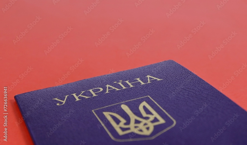 Ukrainian citizen's passport on a red background close-up. Ukrainian citizen's passport on a red background close-up.
