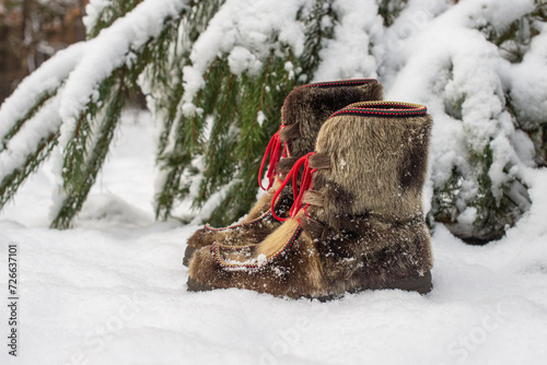 Winter scene with snow boots made of reindeer skin photo