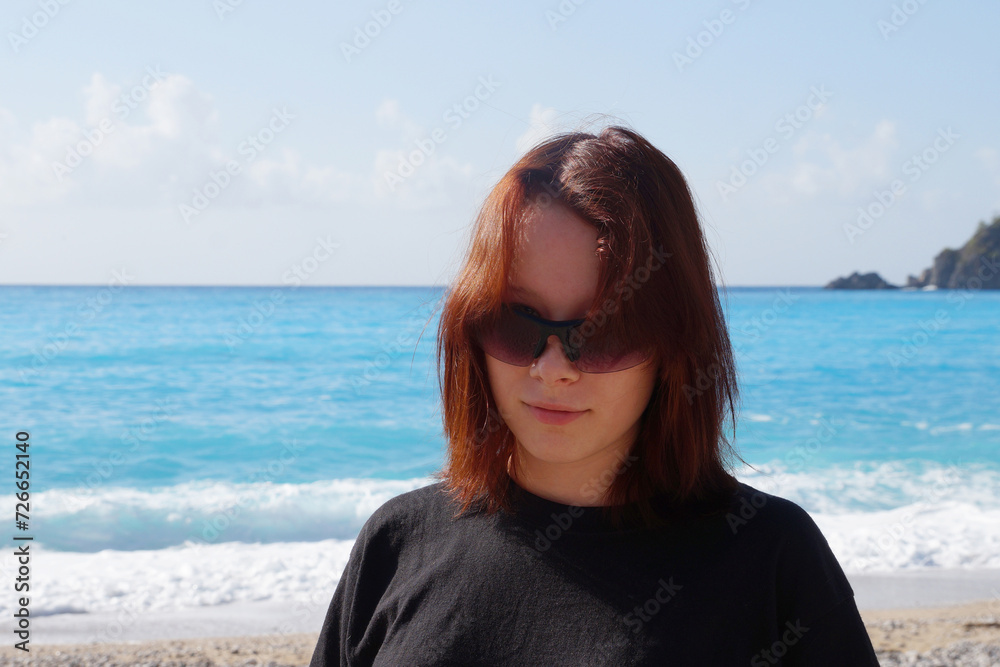 portrait of a smiling teenage girl with brown hair against the background of the sea horizon portrait of a smiling teenage girl with brown hair against the background of the sea horizon