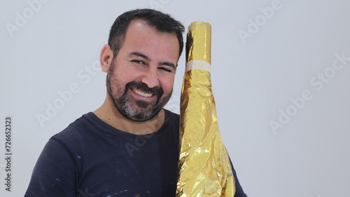 Painter At work Smiling paper gold in hand Paint craftsman And a t-shirt black 