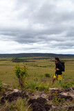 hiking male person with glasses overlooking the savanna in Canaima National Park, Venezuela