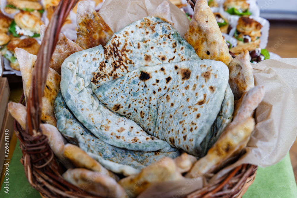 Closeup shot of armenian tasty bread with nettle called Zhingalov hats in the basket