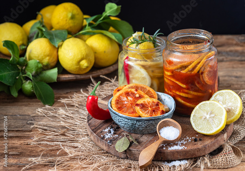 Fermented lemons in jars of salt, chili pepper and rosemary. Traditional food additive in the Middle East, India and North Africa