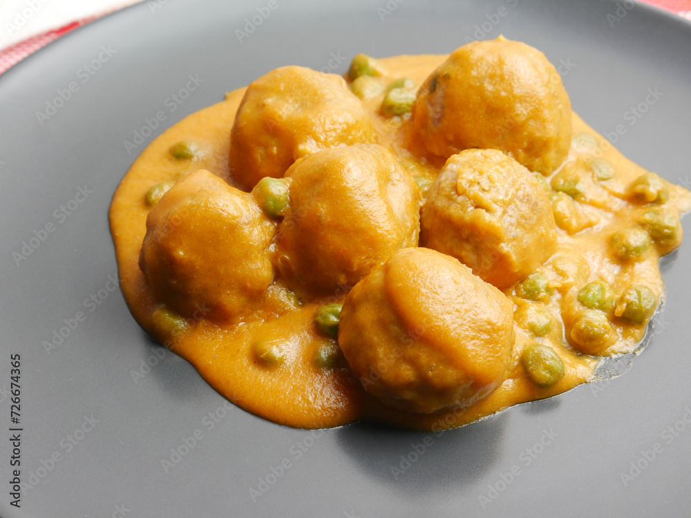 Close up, homemade plate of meatballs with tomato sauce and peas. Close up, homemade plate of meatballs with tomato sauce and peas.
