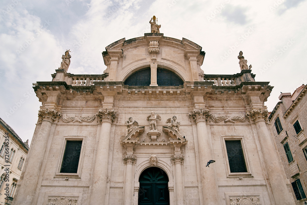Facade of the Church of St. Blaise with sculptures on the roof. Dubrovnik, Croatia