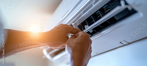 Professional technician inspecting and replacing air conditioning filters with copy space for text photo