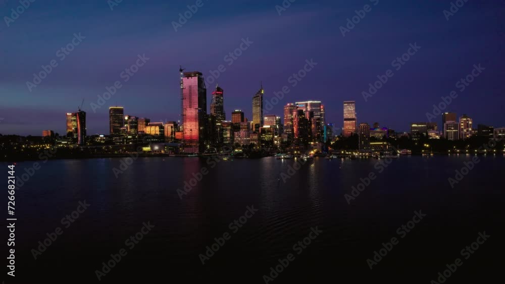 A magnificent view of a bustling city with towering skyscrapers, their twinkling lights reflecting on the tranquil surface of the water. A magnificent view of a bustling city with towering skyscrapers, their twinkling lights reflecting on the tranquil surface of the water.