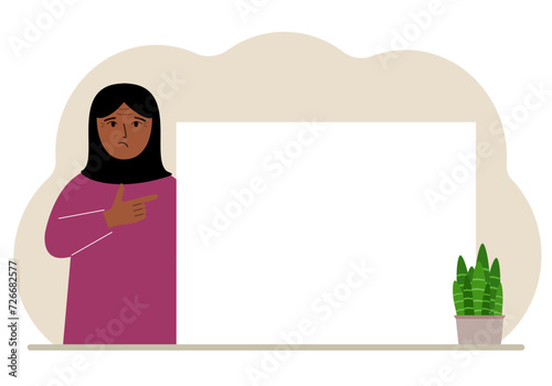 A woman points his finger at a clean large banner, a blank poster or a large white sheet of paper with space for text.