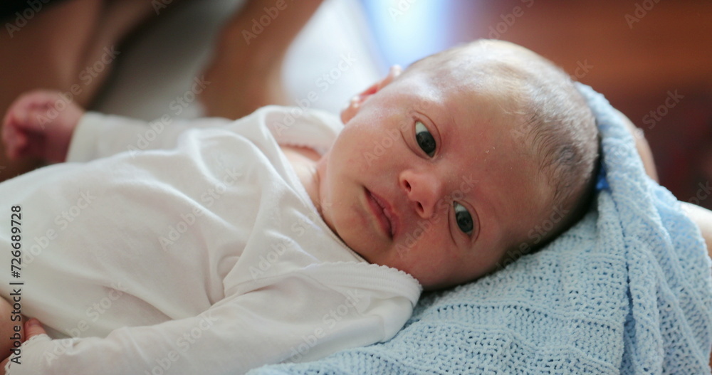 Candid family scene children interaction playing with newborn toddler Candid family scene children interaction playing with newborn toddler