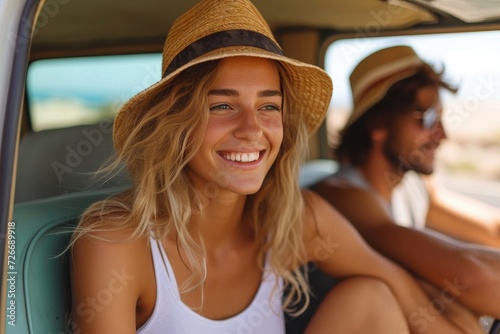 A fashionable woman wearing a wide-brimmed sun hat smiles happily in the back of her car, while her companion looks on wearing a fedora, capturing the carefree essence of a summer day © LifeMedia