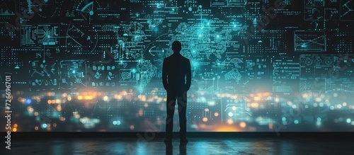 Man silhouette standing before a vast display of glowing data visualizations and technical schematics. A society controlled by technology concept and risk of manipulation photo
