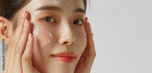 natural skincare beauty concept with a woman touching her face on a white background