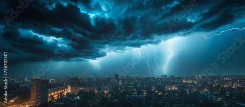 Intense thunderstorm with nighttime rain over urban structures.