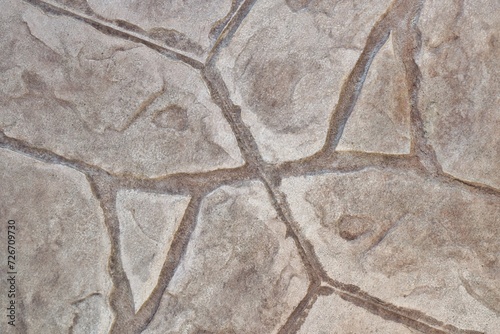 Stamped concrete mosaic patterns, colors and textures from directly above. A procedure of stamping cement to resemble tile, wood or other materials.