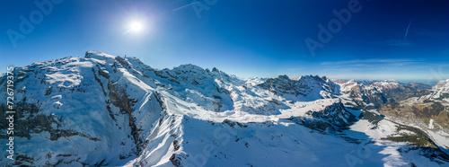 Aerial panoramic winter landscape in Swiss Alps, famous Engelgerg - Titlis ski resort, Switzerland © Martin Valigursky