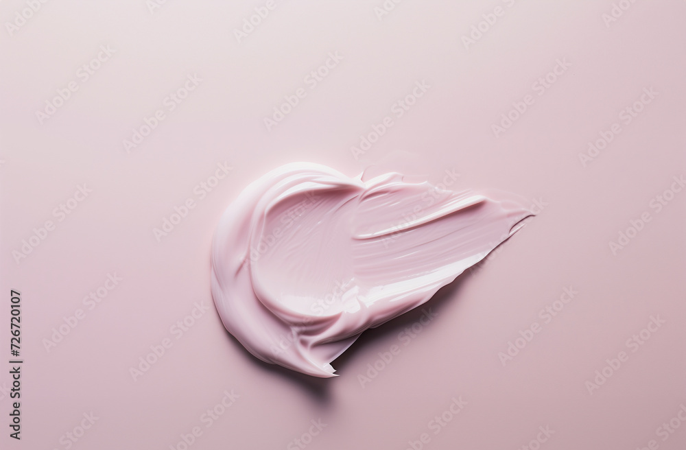 Smear of pink creamy cosmetic product on a pink background. Beauty and skincare concept with a close-up view and space for text. Smear of pink creamy cosmetic product on a pink background. Beauty and skincare concept with a close-up view and space for text.