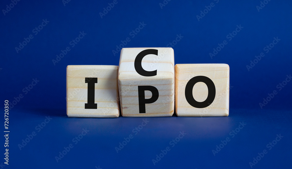 ICO and IPO symbol. Wooden cubes with words ICO - initial coin offering and IPO - initial public offering. Beautiful deep blue background. Business concept. Copy space ICO and IPO symbol. Wooden cubes with words ICO - initial coin offering and IPO - initial public offering. Beautiful deep blue background. Business concept. Copy space